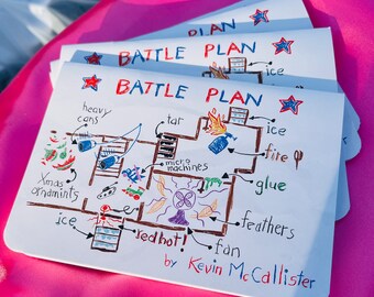 Könnte beinhalten: Ein Stapel weißer Papierblätter mit einer handgezeichneten "BATTLE PLAN"-Zeichnung. Der Plan enthält beschriftete Illustrationen von "heavy cans", "tar", "fire" und "Xmas ornaments". Der Name des Künstlers, Kevin McCallister, steht unten.