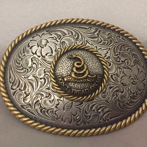 May include: Silver belt buckle with a gold-toned border and a circular inset featuring a coiled snake with the text "Don't Tread On Me".
