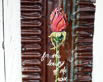 Pink rose on rusty, corrugated tin