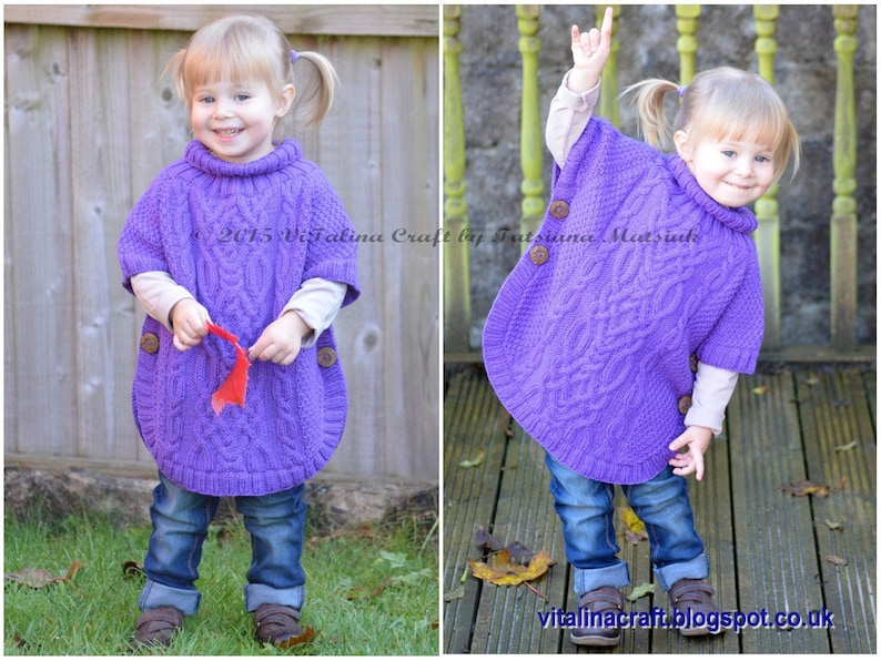 May include: A young child wearing a purple knitted poncho with a cable knit pattern and brown buttons. The child is wearing blue jeans and brown shoes. The poncho has a turtleneck collar. The child is standing in front of a wooden fence and a wooden deck.