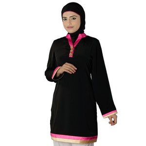 May include: A black long-sleeved tunic with a pink trim and gold buttons. The tunic has a collar and a long, flowing silhouette.