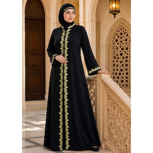 May include: A black floor-length abaya featuring long sleeves and a high neckline. The garment is decorated with intricate yellow embroidery along the front opening, the collar, and the sleeve cuffs. A matching black hijab covers the head.