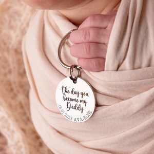 30mm stainless steel engraved keyring. Text reads The day you became my Daddy and is customisable with a child's name and date of birth around the bottom curve of the disc.