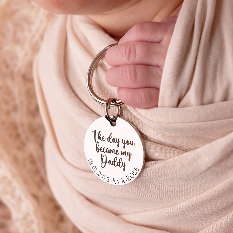 30mm stainless steel engraved keyring. Text reads The day you became my Daddy and is customisable with a child's name and date of birth around the bottom curve of the disc.