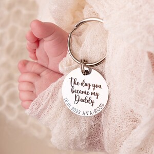 30mm stainless steel engraved keyring. Text reads The day you became my Daddy and is customisable with a child's name and date of birth around the bottom curve of the disc.