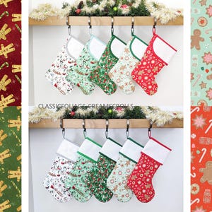 May include: Six Christmas stockings with different patterns, including gingerbread men, candy canes, and snowflakes. The stockings are hung on a wooden rail with greenery behind them.