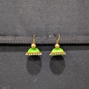 May include: A pair of green silk thread earrings with gold accents and clear rhinestones.