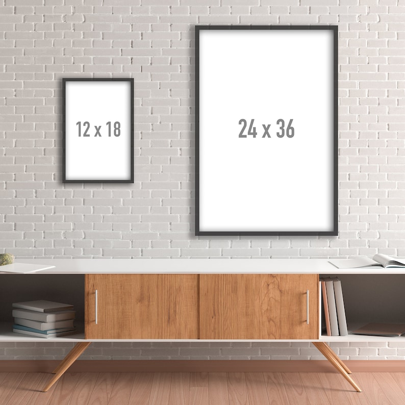 May include: Two black picture frames hanging on a white brick wall above a wooden cabinet with shelves. The larger frame is 24 x 36 inches and the smaller frame is 12 x 18 inches.