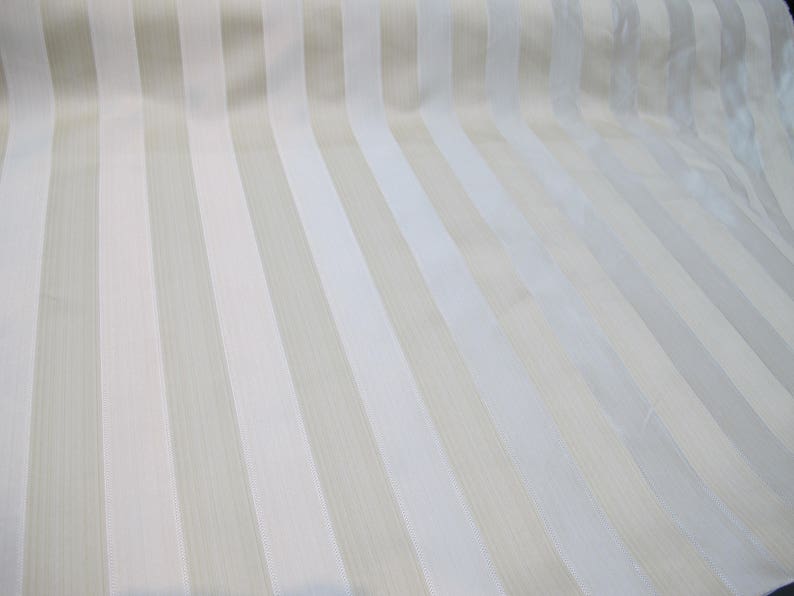 May include: White fabric with beige stripes. The fabric has a subtle sheen and a smooth texture.