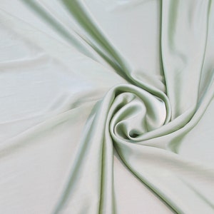 100% Silk Charmeuse Offered in a variety of solid colors, sold by the yard 54 inches wide.
