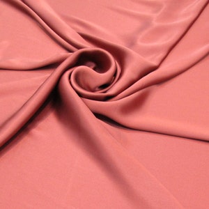 100% Silk Charmeuse Offered in a variety of solid colors, sold by the yard 54 inches wide.