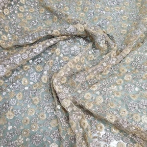 Gold color embroidered  netting soft tulle fabric usable for apparel,accessories and interior designing.  45 inches wide.