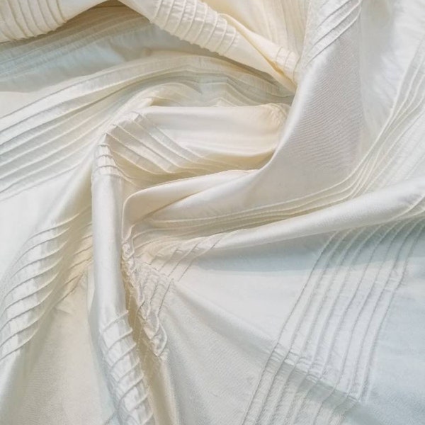 100% Silk shantung Ivory pinstripe pintuck 48" wide usable for apparel accessories and interior designs. Striped stitching style fabric.