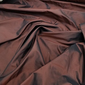 Maroon a dark  red color silk taffeta. 54&quot; wide. Taffeta is a crisp, smooth, woven fabric suitable for use in ball gown dress and weddings.