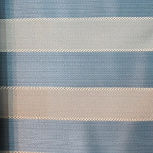May include: A striped fabric with alternating bands of light blue and beige. The fabric has a subtle texture and a woven appearance.