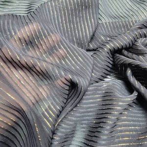 100% Silk chiffon metallic striped  design. Rich and beautiful gold mettallic stripes on black  silk chiffon to create formal and evening we