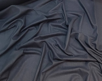 May include: A close-up of a dark grey fabric with a smooth, soft texture. The fabric is draped and folded, showcasing its drape and flow.