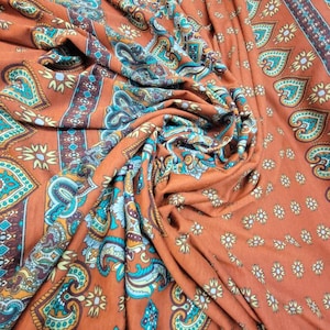 Rust color Soft jersey knit  fabric beautifully printed 60 inches wide usable for fashion designers costumes and interior designing.