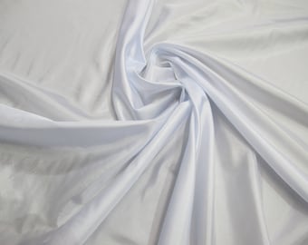 White color 60 inches polyester China Silk lining fabric. This fabric is soft light weight and has a sheen to it. Wholesale price available.