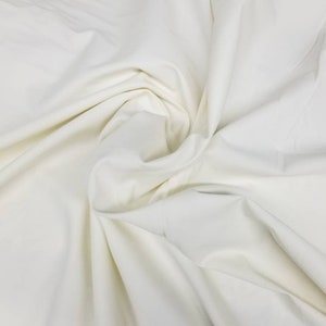 Off white/ Ivory Stretch Cotton Satin  Fabric Cotton satin  fabrics are a luxurious  that have a heavier weight. 54&quot; wide.