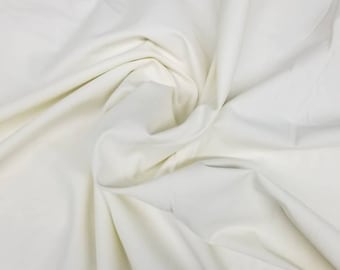Off white/ Ivory Stretch Cotton Satin  Fabric Cotton satin  fabrics are a luxurious  that have a heavier weight. 54" wide.