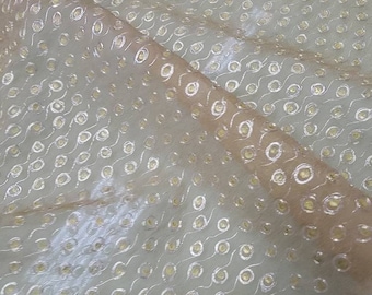 May include: Beige sheer fabric with a repeating pattern of silver and gold circles.