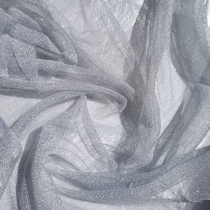 Metallic silver netting soft tulle fabric usable for apparel,accessories and interior designing.  45 inches wide.