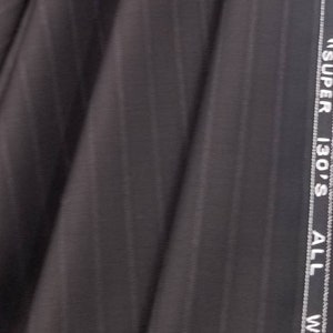 May include: Close-up of a dark gray fabric with a subtle striped pattern. The fabric has a white label with the text "SUPER 130'S ALL WOOL" along the edge.