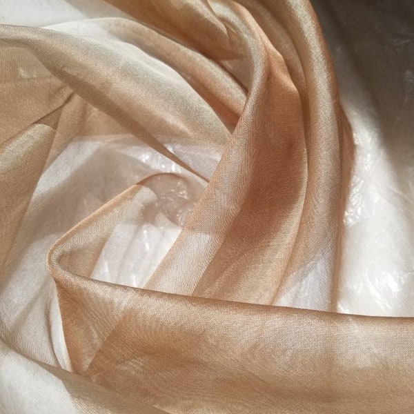 100% Silk Organza irredescent color Bronze Champagne    54" wide. Usable for apparel,accessories, interior designs and much more.