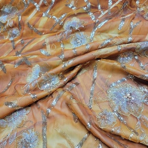 100% Silk chiffon metallic sequenced floral  design. Rich and beautiful sequenced silk chiffon to create formal and evening wear.