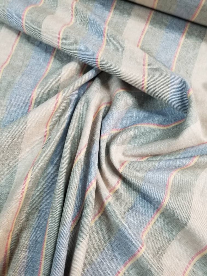 Pu&ograve; includere: Tessuto a righe in tonalit&agrave; di blu, verde, rosa e beige. Il tessuto ha una trama tessuta e un motivo a righe diagonali.