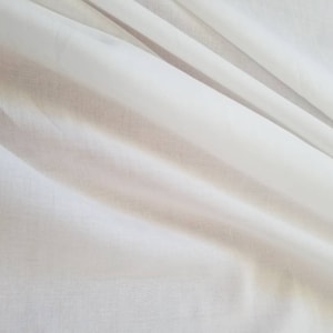 Off White color Mercerised 100% soft Cotton Voile fabric usable for apparel,accessories and interior designing 45 inches wide.