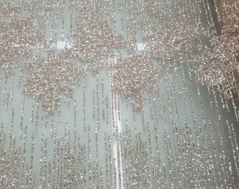 Glitter Metallic fabric usable for decoration and apparel. 58" Wide sold by the yard.