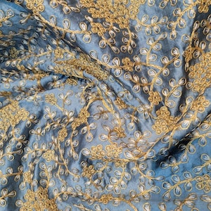 Shantung fabric beautifully gold thread embroidered with unique look that takes its elegant. 45&quot; Wide fabric.