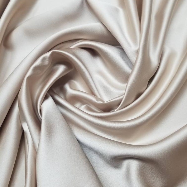 Beige champagne color fine satin  fabric. Usable for apparel,accessories  and interior designing.