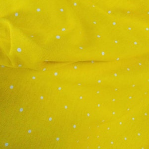 Yellow color Soft jersey knit with white tiny polka dots  fabric beautifully made 60 inches wide usable for fashion designers.