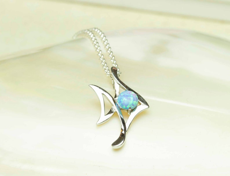 Sterling Silver Sky Blue Lab Opal Fish Pendant Shell Background