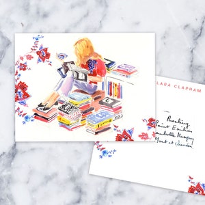 May include: A watercolor illustration of a woman sitting on a stack of books, reading a book. The woman is wearing a red shirt and blue pants. The illustration is surrounded by a floral border. The text "Lara Clapham" is written in the upper right corner of the image. The text "Reading Saint Exupery, Gabrielle Murray, Yeats et Clarendon." is written in the lower right corner of the image.