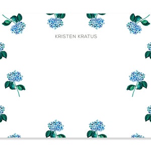 May include: White stationery with a blue and green floral pattern. The text "KRISTEN KRATUS" is printed in the center of the card.