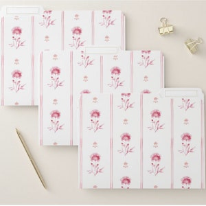 May include: Three white file folders with a pink floral pattern. The pattern features pink flowers with green stems and leaves on a white background with thin pink stripes.