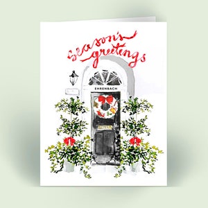 May include: A watercolor illustration of a black door with a wreath and red bows. The door has a sign that reads "Ehrenbach". The text "Season's Greetings" is written in red cursive above the door.