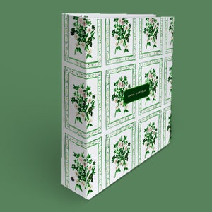 May include: A white binder with a green floral pattern and a green label that says "ANNA SMITH".