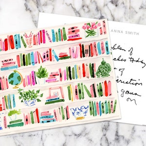 May include: A postcard with a colorful illustration of a bookshelf filled with books, plants, and decorative items. The back of the postcard has handwritten text that says "Anna Smith" and "Problem is, I'm going to be busy today.  I'm going to be busy tomorrow.  I'm going to be busy forever."