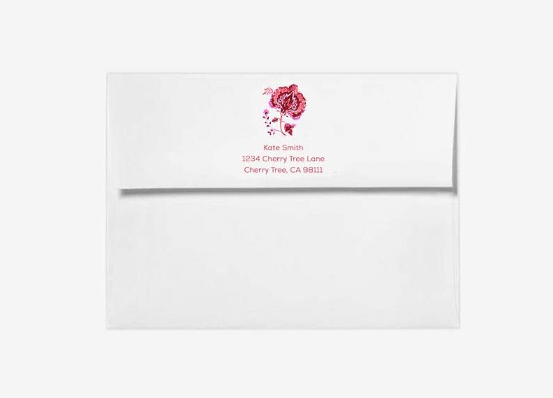 May include: White envelope with a pink floral design and the text "Kate Smith, 1234 Cherry Tree Lane, Cherry Tree, CA 98111"
