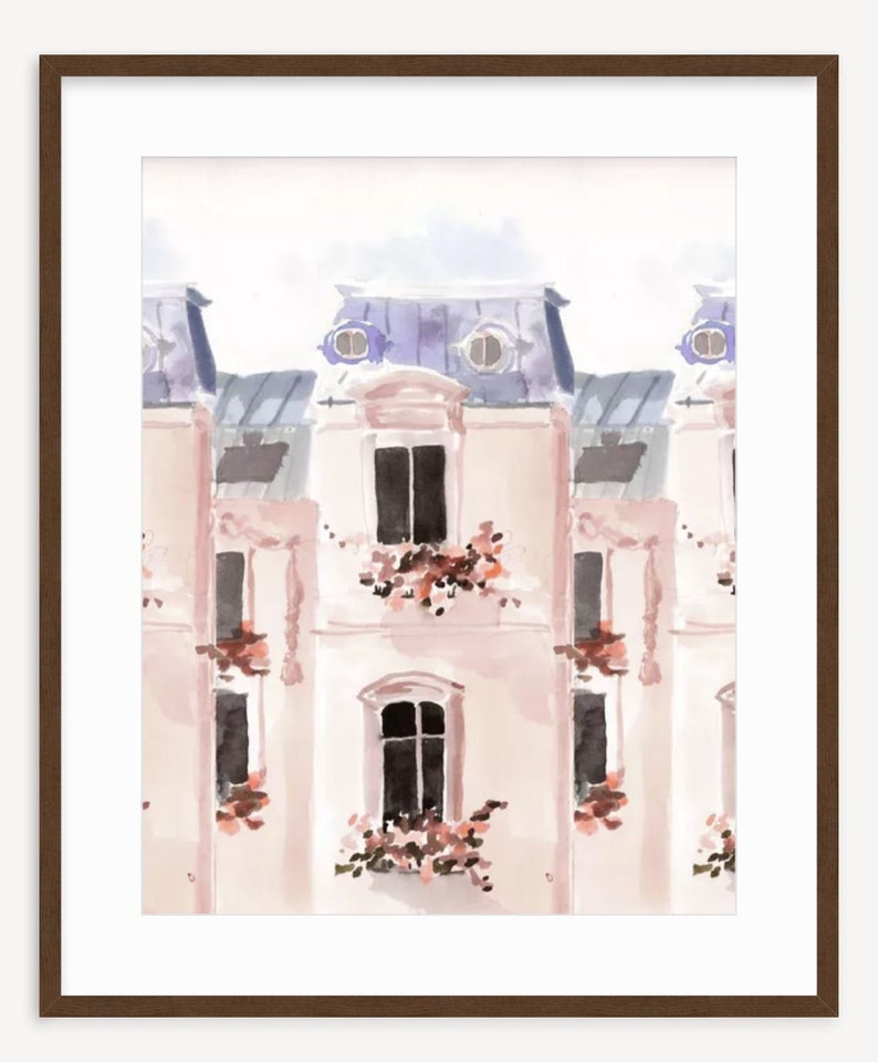 May include: Watercolor painting of a Parisian building facade. The artwork features a repeating pattern of light pink buildings with blue roofs, black windows, and flower boxes. The image is framed in a dark brown wooden frame.