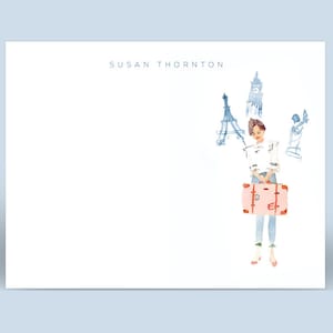 May include: A watercolor illustration of a woman with a suitcase, standing in front of a background of Parisian landmarks, including the Eiffel Tower and the Arc de Triomphe. The text "SUSAN THORNTON" is at the top of the image.