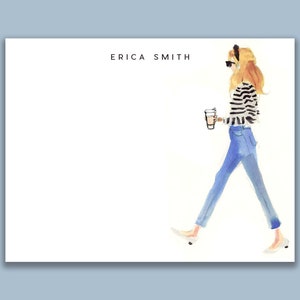 May include: A watercolor illustration of a woman walking with a cup of coffee. She is wearing a striped shirt, blue jeans, and white shoes. The illustration is on a white background with the text "ERICA SMITH" at the top.