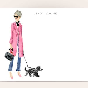 May include: A woman in a pink coat, sunglasses, and a black scarf walks a black dog on a leash. The text "CINDY BOONE" is at the top of the image.