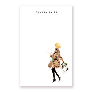 May include: A woman in a leopard print coat walks with a shopping bag and a bouquet of red flowers. The text "TAMARA SMITH" is at the top of the image.