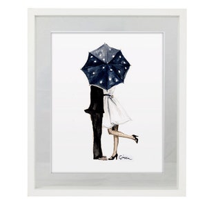 May include: Watercolour art print showing a couple kissing beneath a navy blue umbrella with white polka dots. The artwork depicts a man in a black suit and a woman in a white dress, framed in a white border.